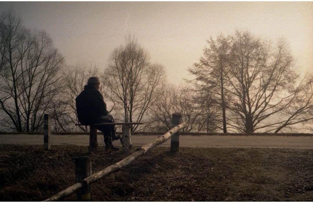 Figure on a bench in the fog